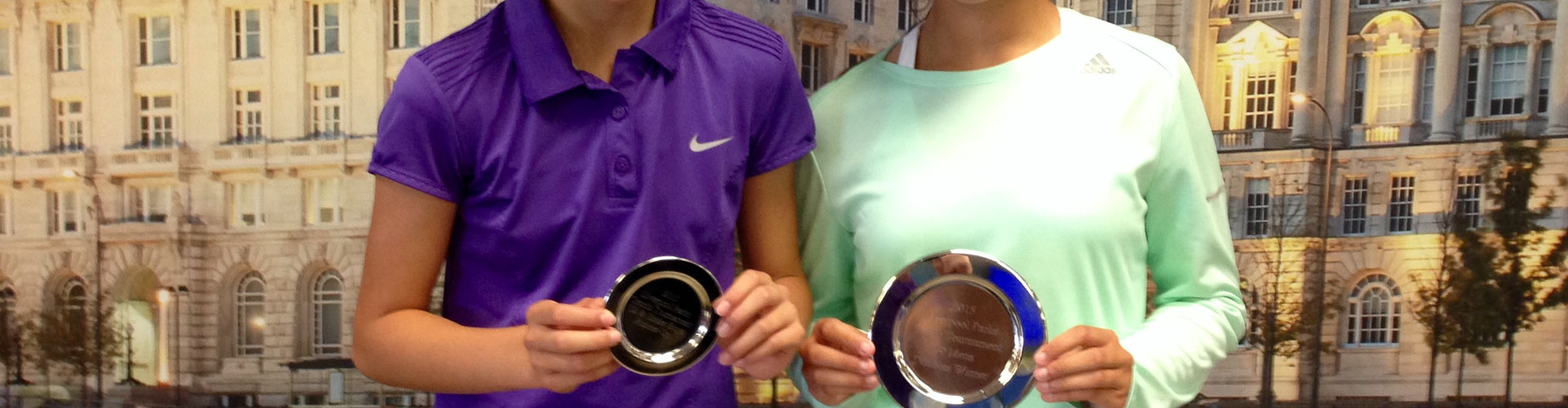 Players holding Tennis trophies