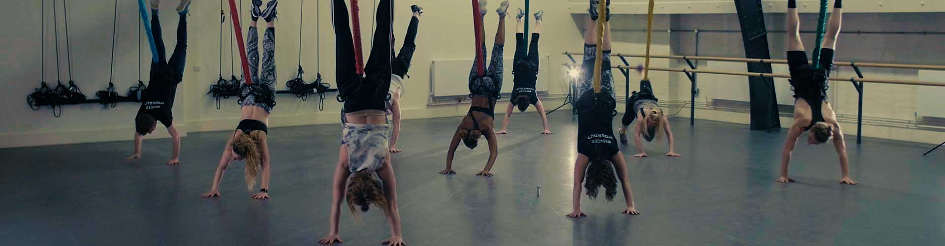 Bungee workout class doing handstands